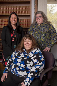 NHLA Benefits Project co-director, Megan Dillon with clients Tina (seated) and Karen. 